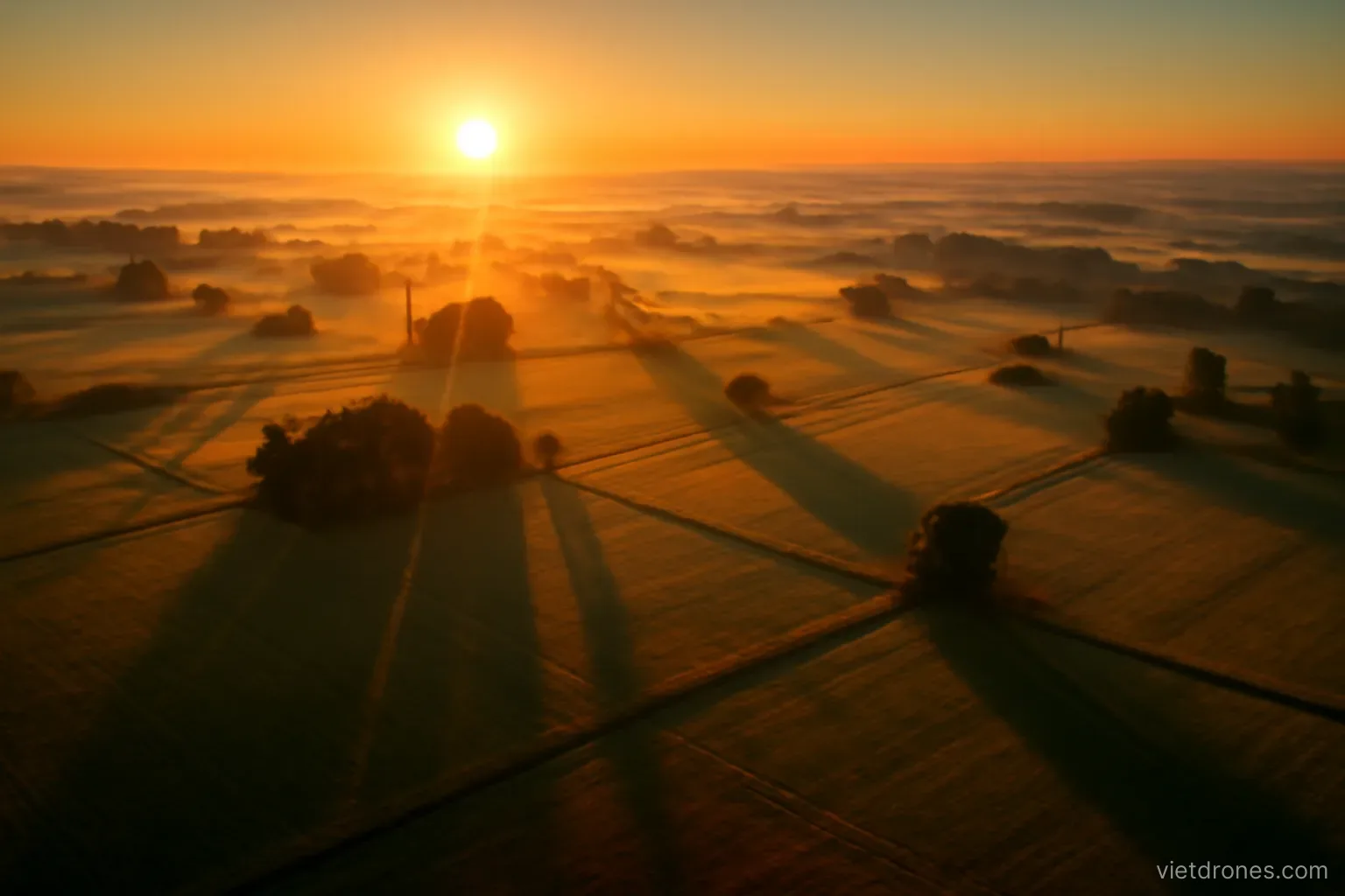 A landscape at sunrise seen from above with long shadows